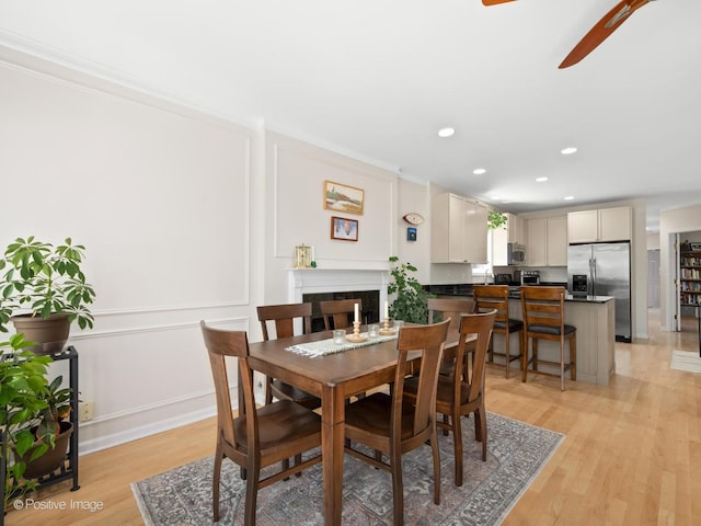 840 N Wood St Unit 2, Chicago, IL 60622 - dining room with recessed lighting, light wood-style floors, a ceiling fan, a fireplace, and a decorative wall