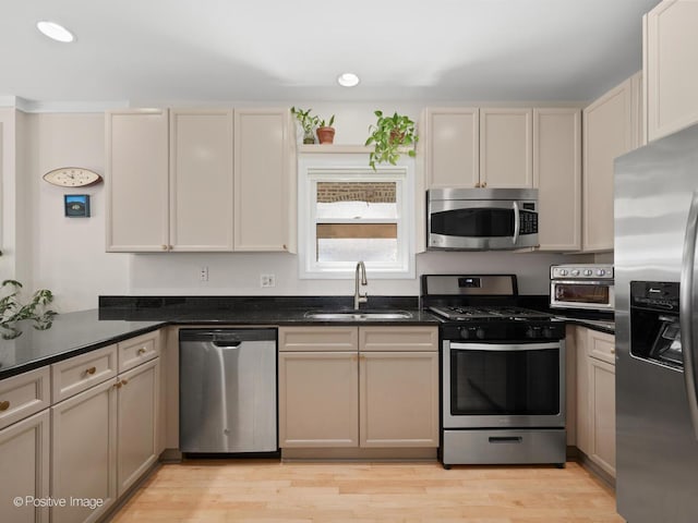 840 N Wood St Unit 2, Chicago, IL 60622 - kitchen featuring stainless steel appliances, a sink, light wood-type flooring, recessed lighting, and dark stone counters