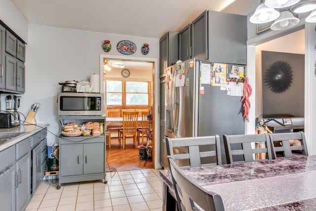 2105 Caton Farm Rd, Crest Hill, IL 60403 - kitchen featuring appliances with stainless steel finishes, light tile patterned flooring, gray cabinets, and light countertops