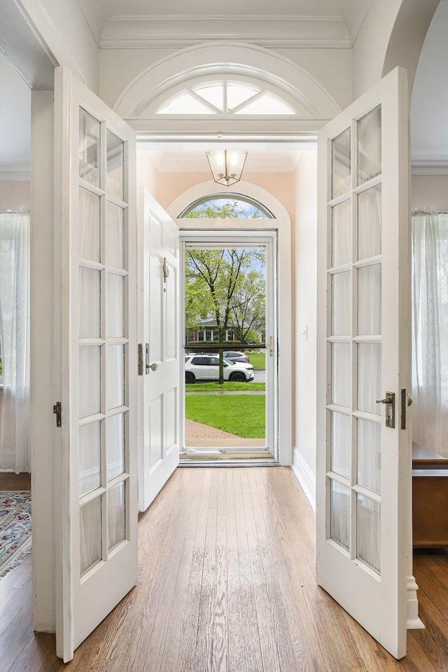 230 N Wisner St, Park Ridge, IL 60068 - entrance foyer featuring french doors, wood finished floors, arched walkways, crown molding, and a chandelier