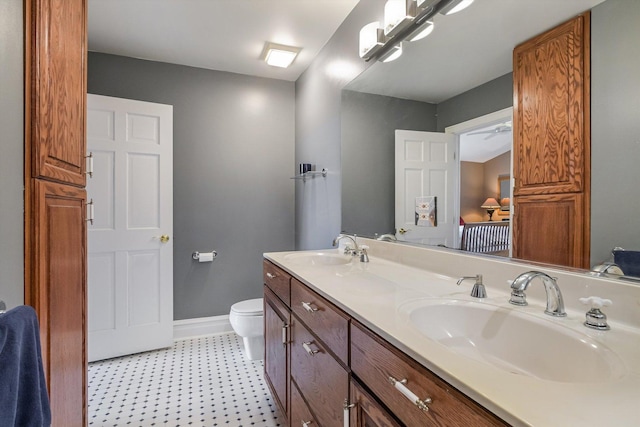 230 N Wisner St, Park Ridge, IL 60068 - full bathroom with double vanity, toilet, baseboards, and tile patterned floors