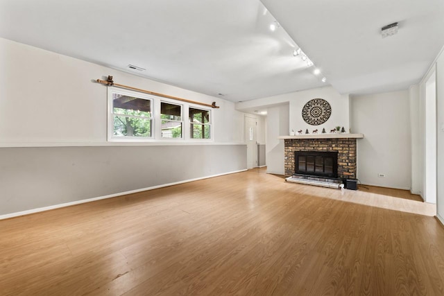 169 S Ellyn Ave, Glen Ellyn, IL 60137 - unfurnished living room featuring wood finished floors, track lighting, and a brick fireplace