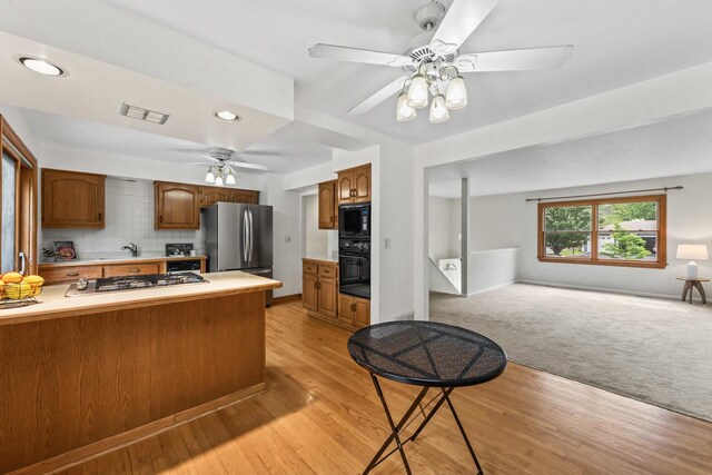 169 S Ellyn Ave, Glen Ellyn, IL 60137 - kitchen featuring black appliances, ceiling fan, open floor plan, light countertops, and tasteful backsplash