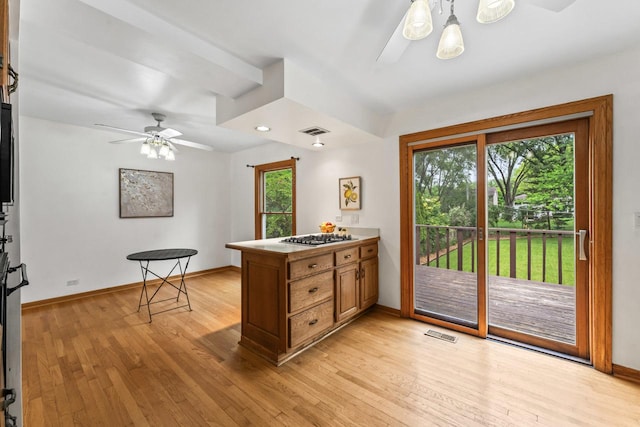 169 S Ellyn Ave, Glen Ellyn, IL 60137 - kitchen featuring a ceiling fan, light wood-style floors, a peninsula, brown cabinetry, and stainless steel gas cooktop