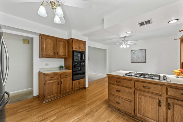 169 S Ellyn Ave, Glen Ellyn, IL 60137 - kitchen with black appliances, ceiling fan, light wood-type flooring, light countertops, and brown cabinets