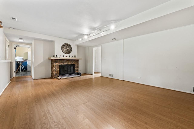 169 S Ellyn Ave, Glen Ellyn, IL 60137 - unfurnished living room featuring wood finished floors, a fireplace, and track lighting