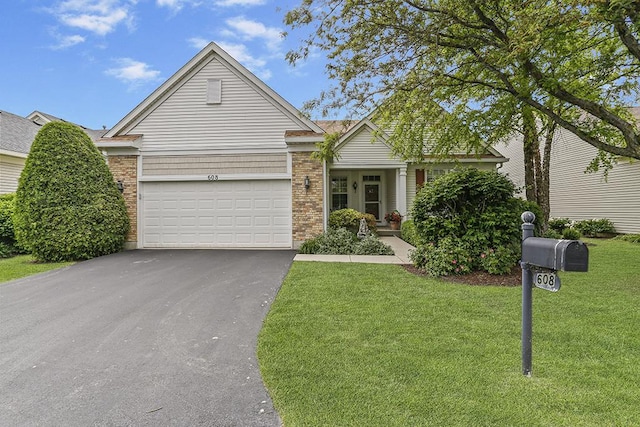 608 Bridgeman Ln, Romeoville, IL 60446 - view of front of home with driveway, a front lawn, a garage, and brick siding