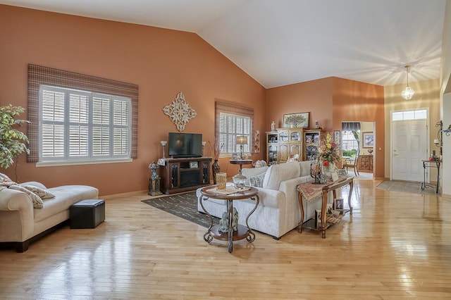 608 Bridgeman Ln, Romeoville, IL 60446 - living room with healthy amount of natural light, vaulted ceiling, light wood-type flooring, and baseboards