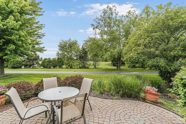 608 Bridgeman Ln, Romeoville, IL 60446 - view of patio with outdoor dining area and view of scattered trees