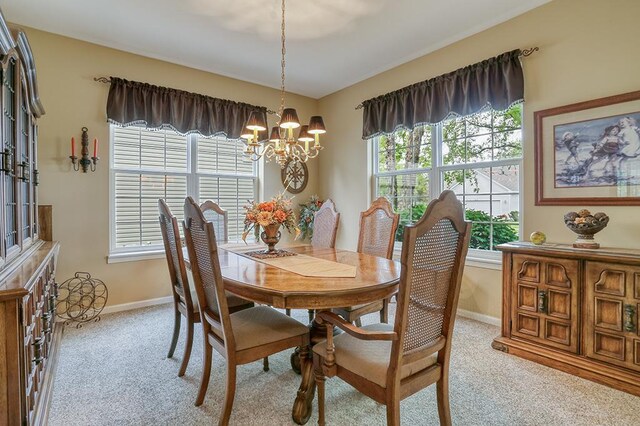 608 Bridgeman Ln, Romeoville, IL 60446 - dining room featuring a chandelier, light colored carpet, plenty of natural light, and baseboards