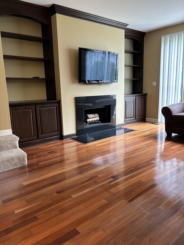 308 Glen Leven Ct Unit 308, Schaumburg, IL 60194 - unfurnished living room featuring built in features, wood finished floors, baseboards, and a fireplace with raised hearth