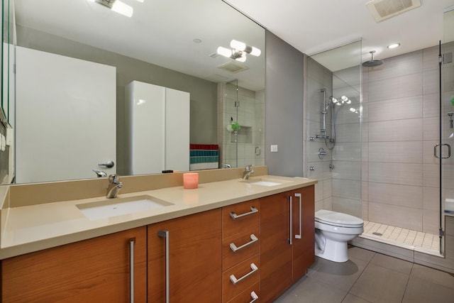 1570 Elmwood Ave Unit 910, Evanston, IL 60201 - bathroom featuring tile patterned flooring, a stall shower, double vanity, and toilet