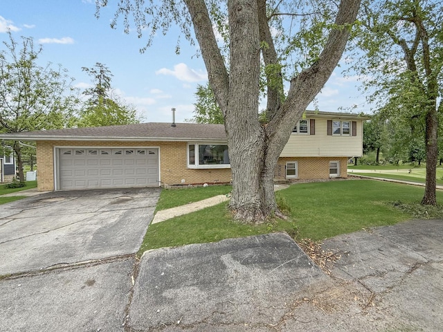425 Maxwell St, Beecher, IL 60401 - tri-level home featuring brick siding, a garage, a front lawn, and driveway
