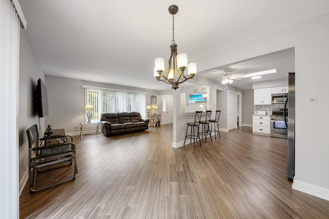 17828 Massachusetts Ct, Orland Park, IL 60467 - living area featuring a chandelier, wood finished floors, a ceiling fan, and baseboards