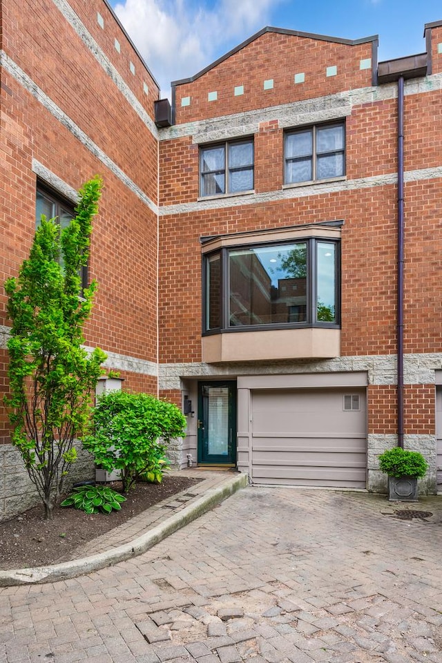 2720 N Greenview Ave Unit C, Chicago, IL 60614 - view of front of property featuring decorative driveway, an attached garage, and brick siding