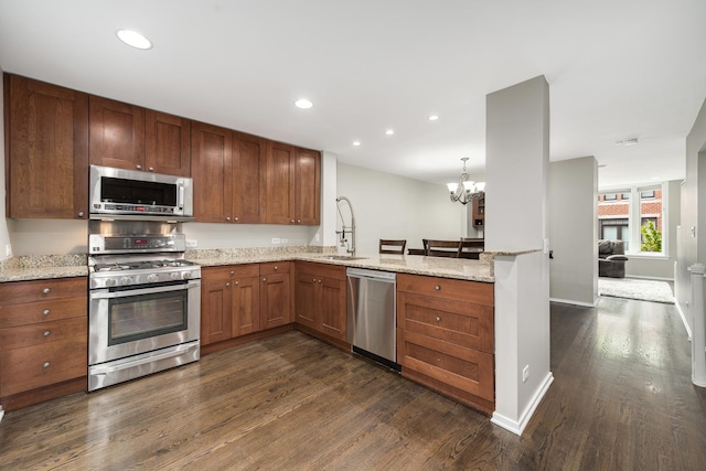 2720 N Greenview Ave Unit C, Chicago, IL 60614 - kitchen with stainless steel appliances, a sink, dark wood-style flooring, a peninsula, and a chandelier