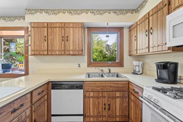 137 N Clark Dr, Palatine, IL 60074 - kitchen with white appliances, a sink, light countertops, and brown cabinetry