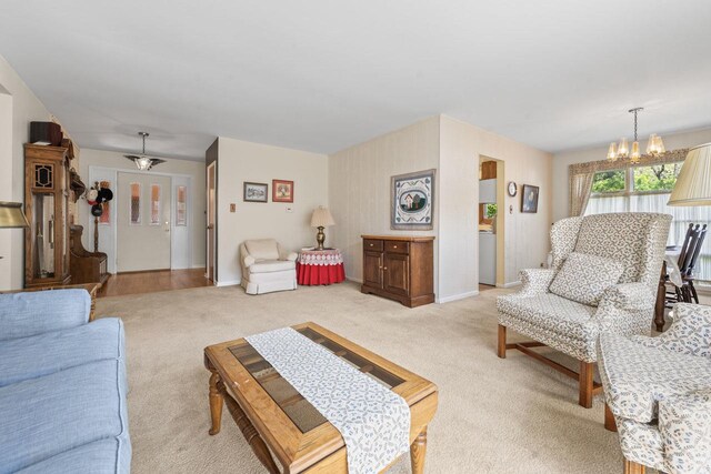 137 N Clark Dr, Palatine, IL 60074 - living room featuring a chandelier, light carpet, and baseboards