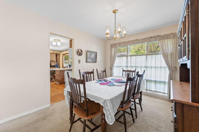 137 N Clark Dr, Palatine, IL 60074 - dining area featuring a chandelier, light colored carpet, and baseboards