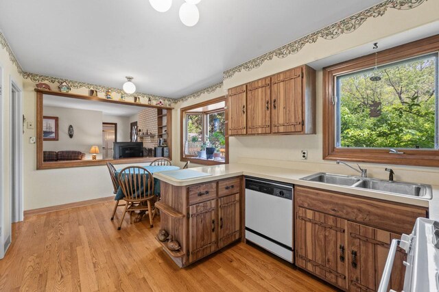137 N Clark Dr, Palatine, IL 60074 - kitchen featuring dishwasher, a sink, brown cabinetry, a peninsula, and range