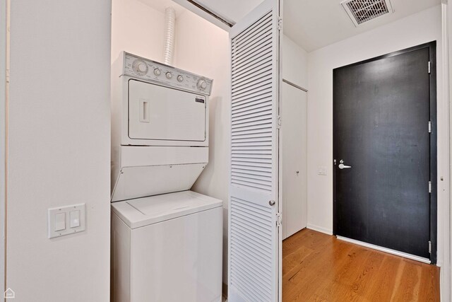240 E Illinois St Unit 805, Chicago, IL 60611 - laundry area featuring stacked washer / drying machine and light wood finished floors