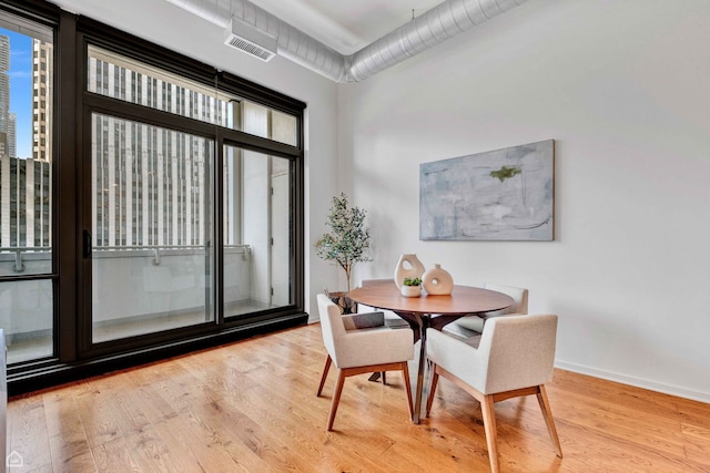 240 E Illinois St Unit 805, Chicago, IL 60611 - dining room featuring wood finished floors and baseboards