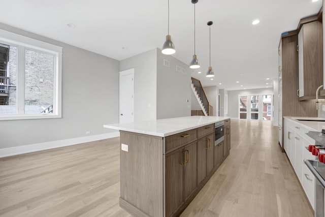 2353 W Ohio St, Chicago, IL 60612 - kitchen featuring healthy amount of natural light, light wood-type flooring, a center island, and recessed lighting