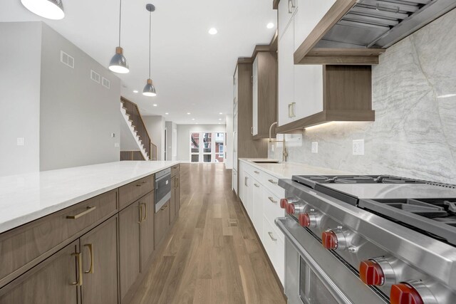 2353 W Ohio St, Chicago, IL 60612 - kitchen featuring gas stove, light wood-style floors, light countertops, tasteful backsplash, and recessed lighting