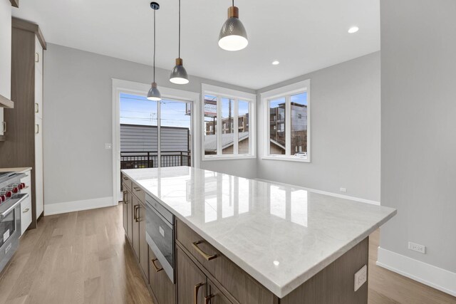 2353 W Ohio St, Chicago, IL 60612 - kitchen with appliances with stainless steel finishes, light wood-style flooring, baseboards, light stone countertops, and recessed lighting