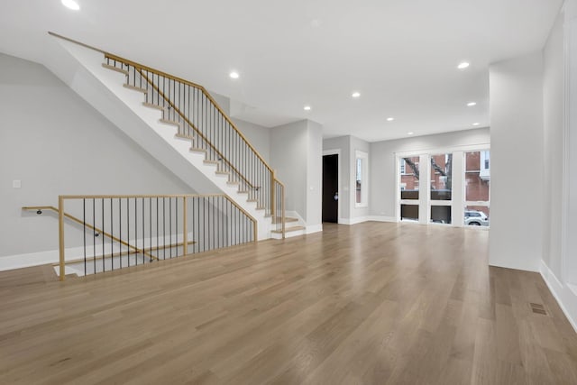 2353 W Ohio St, Chicago, IL 60612 - unfurnished living room with wood finished floors, recessed lighting, baseboards, and stairway