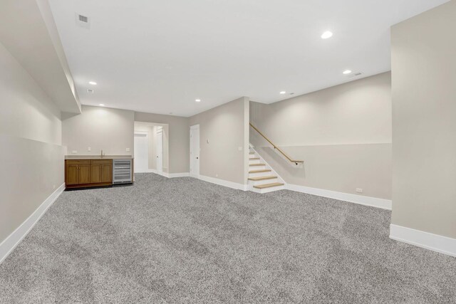 2353 W Ohio St, Chicago, IL 60612 - unfurnished living room featuring beverage cooler, carpet flooring, baseboards, recessed lighting, and stairway