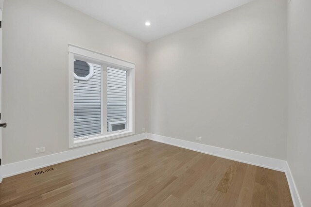 2353 W Ohio St, Chicago, IL 60612 - spare room featuring wood finished floors, baseboards, and recessed lighting