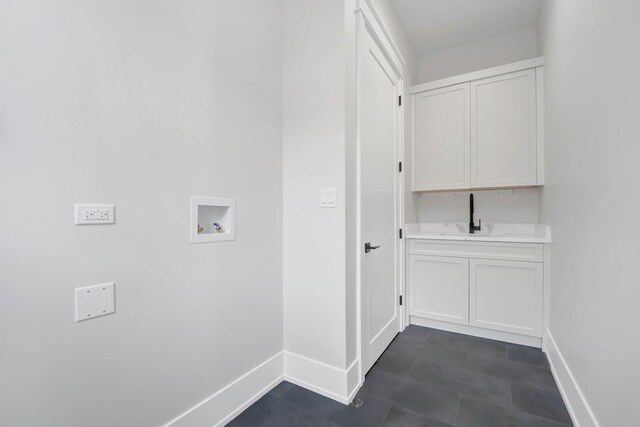 2353 W Ohio St, Chicago, IL 60612 - laundry area featuring washer hookup, cabinet space, baseboards, and dark tile patterned floors