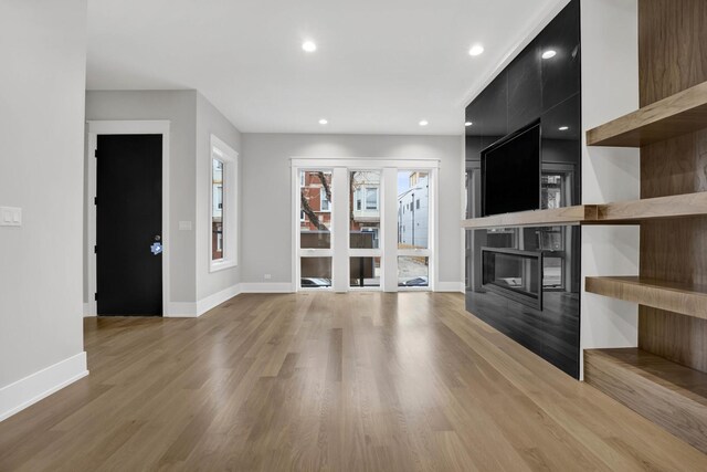 2353 W Ohio St, Chicago, IL 60612 - unfurnished living room with a fireplace, baseboards, light wood-style floors, and recessed lighting