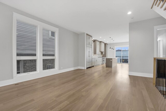 2353 W Ohio St, Chicago, IL 60612 - unfurnished living room with light wood-style floors, baseboards, and recessed lighting