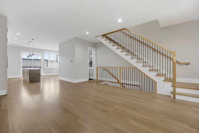 2353 W Ohio St, Chicago, IL 60612 - unfurnished living room with wood finished floors, baseboards, recessed lighting, and stairs