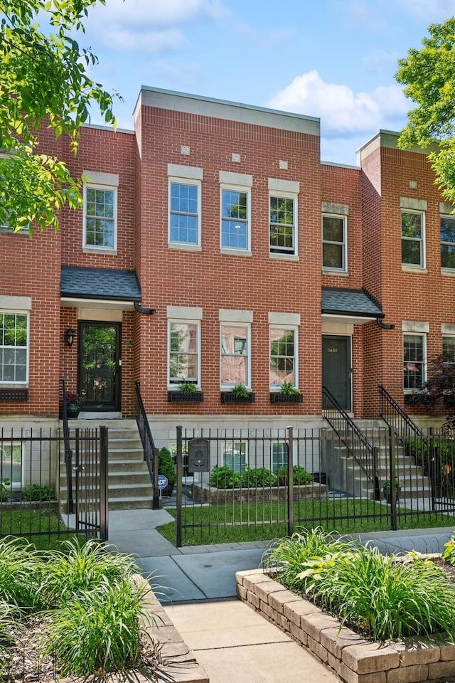 1448 N Mohawk St, Chicago, IL 60610 - townhome / multi-family property with brick siding and a fenced front yard