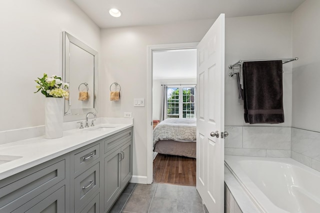 1448 N Mohawk St, Chicago, IL 60610 - bathroom with double vanity, a bath, connected bathroom, tile patterned floors, and recessed lighting