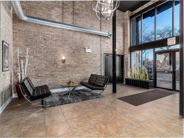 50 E 26th St Unit 406, Chicago, IL 60616 - building lobby featuring a high ceiling and brick wall