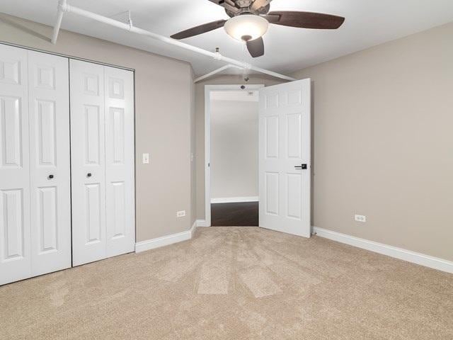 50 E 26th St Unit 406, Chicago, IL 60616 - unfurnished bedroom featuring carpet flooring, a closet, baseboards, and a ceiling fan