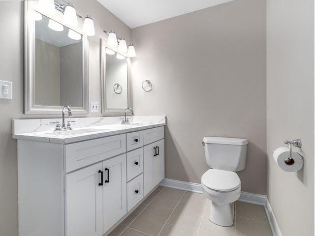 50 E 26th St Unit 406, Chicago, IL 60616 - bathroom with double vanity, toilet, baseboards, and tile patterned flooring