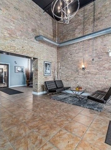 50 E 26th St Unit 406, Chicago, IL 60616 - community lobby featuring a high ceiling and brick wall