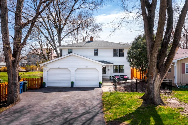 206-208 N Fremont St, Naperville, IL 60540 - view of front facade featuring driveway, a garage, a chimney, and a shingled roof