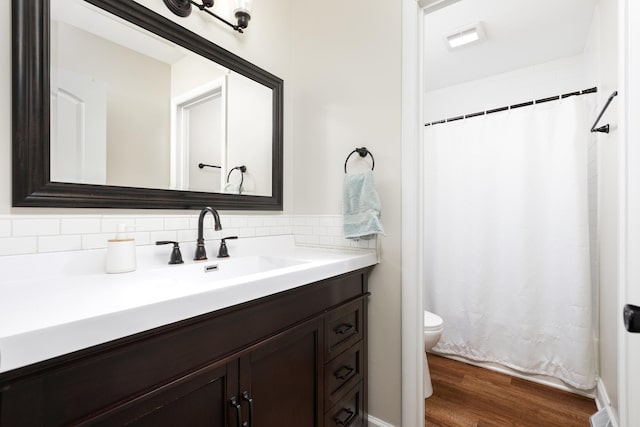 206-208 N Fremont St, Naperville, IL 60540 - bathroom featuring toilet, vanity, wood finished floors, a shower with curtain, and decorative backsplash