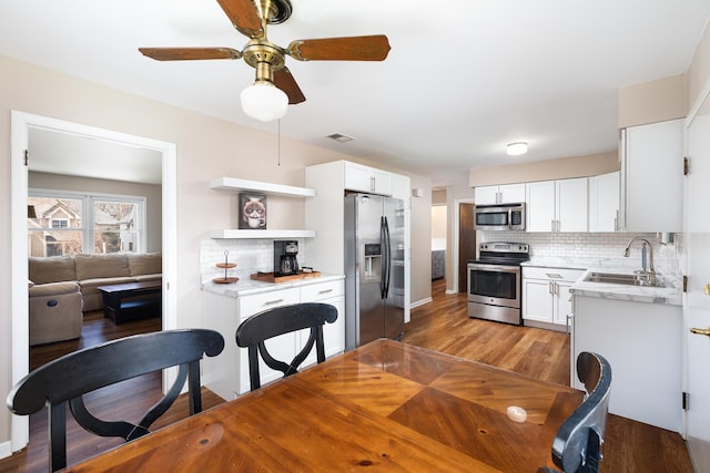 206-208 N Fremont St, Naperville, IL 60540 - kitchen featuring appliances with stainless steel finishes, a sink, light wood finished floors, and decorative backsplash