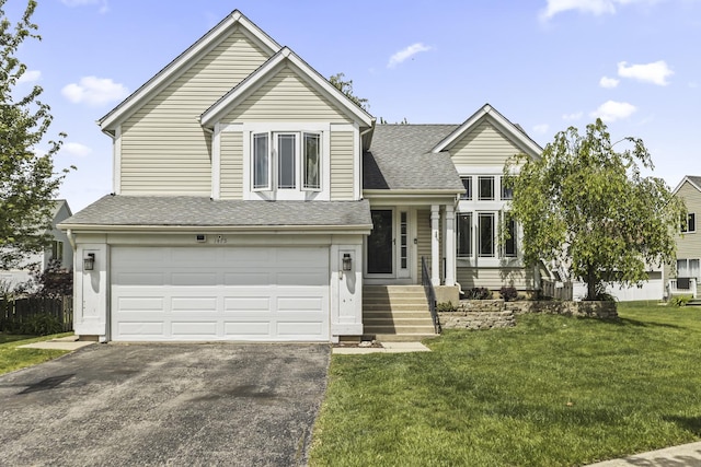 1475 Beaumont Cir, Bartlett, IL 60103 - split level home featuring driveway, an attached garage, a front lawn, and a shingled roof