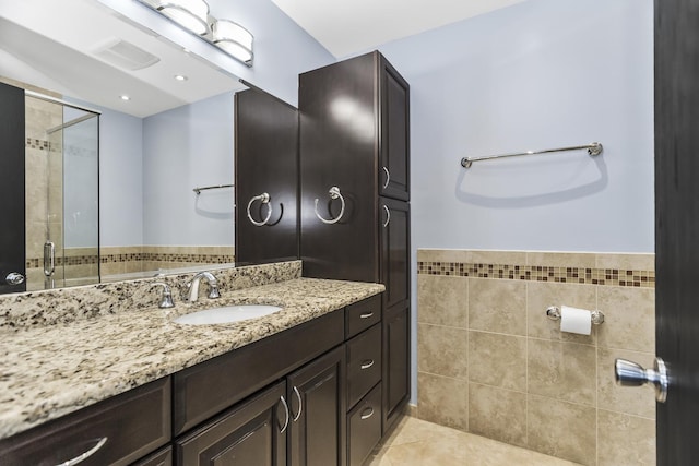 1475 Beaumont Cir, Bartlett, IL 60103 - full bath with vanity, tile patterned floors, tile walls, and tiled shower