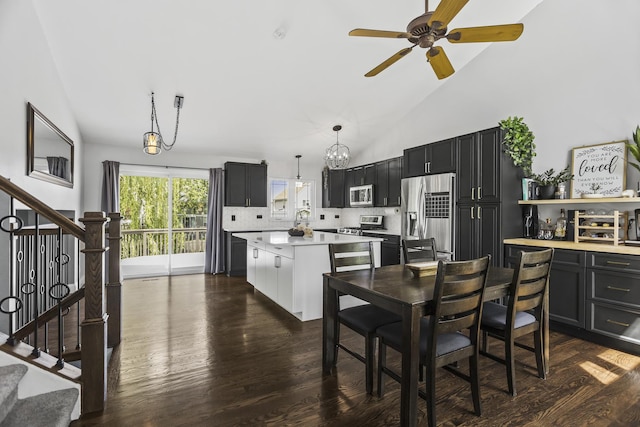 1475 Beaumont Cir, Bartlett, IL 60103 - dining space with dark wood-style floors, stairs, ceiling fan, high vaulted ceiling, and a chandelier