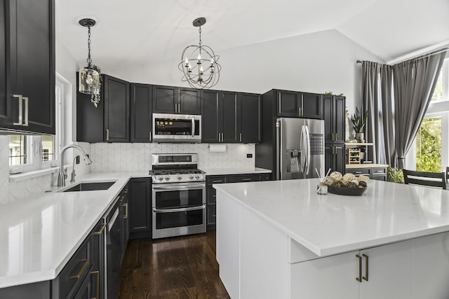 1475 Beaumont Cir, Bartlett, IL 60103 - kitchen with appliances with stainless steel finishes, a sink, vaulted ceiling, dark wood-style floors, and a chandelier