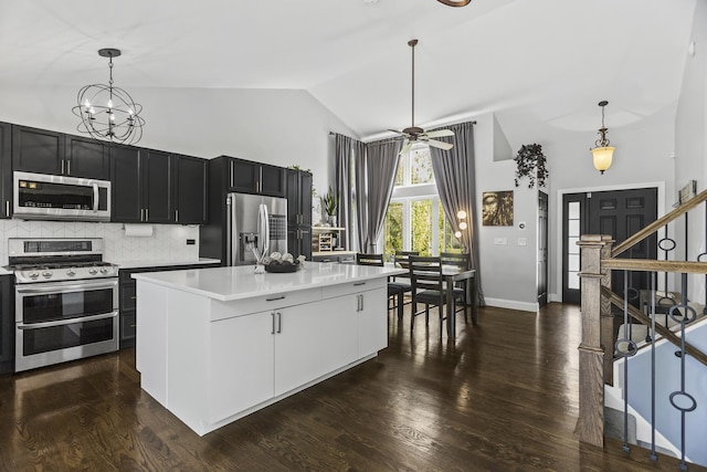 1475 Beaumont Cir, Bartlett, IL 60103 - kitchen featuring appliances with stainless steel finishes, high vaulted ceiling, light countertops, backsplash, and decorative light fixtures